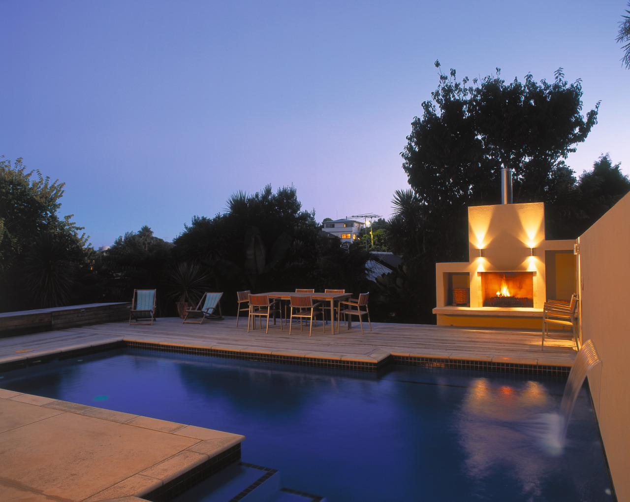 view of the outdoor entertainment area and mayfair backyard, estate, evening, home, house, lighting, property, real estate, reflection, residential area, roof, sky, swimming pool, villa, water, blue