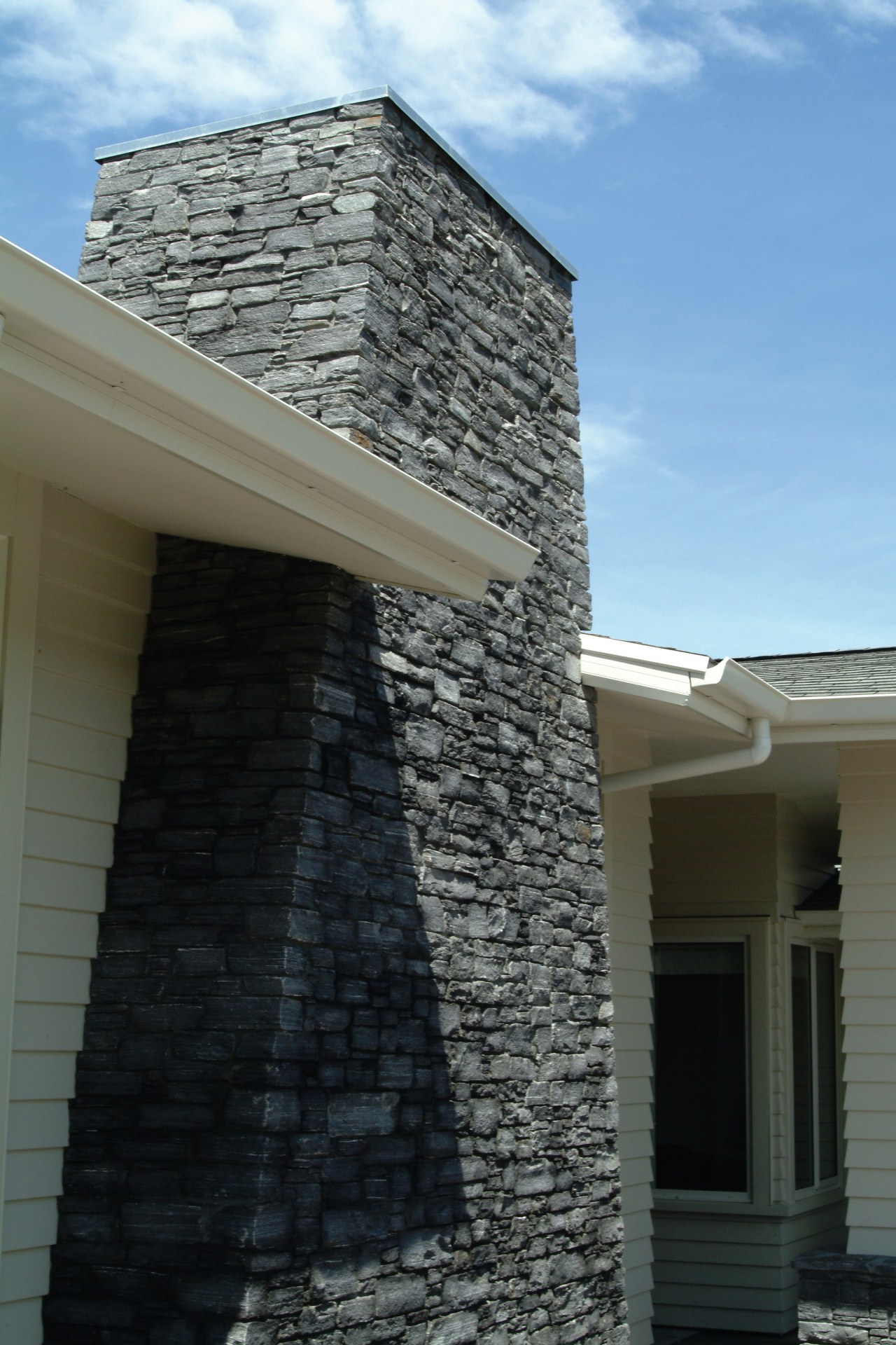 Closeup of exterior schist chimney. architecture, brick, brickwork, building, facade, home, house, roof, siding, sky, wall, window, black, gray