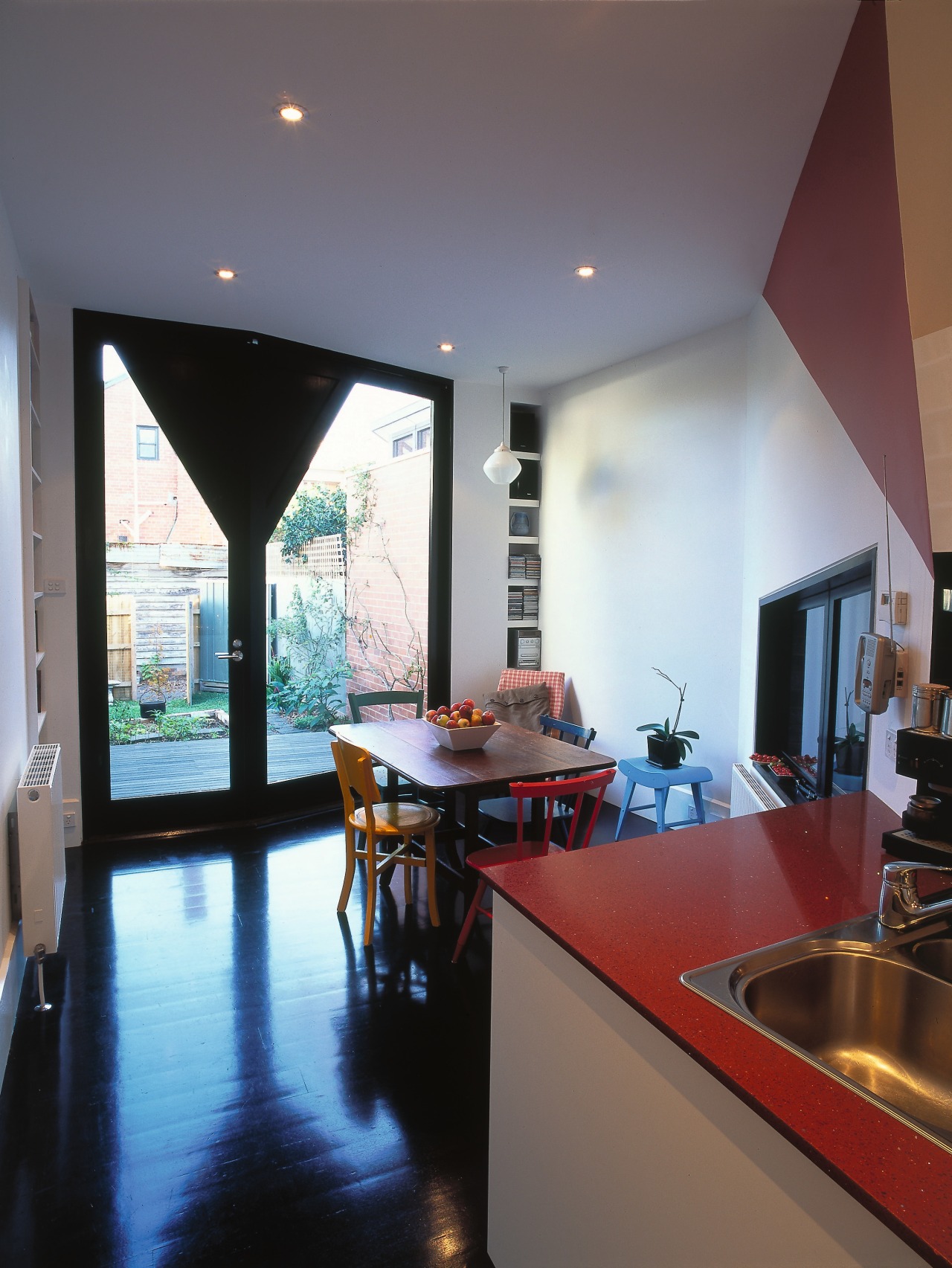 view of the kitchen and dining area showing architecture, ceiling, countertop, daylighting, flooring, home, house, interior design, kitchen, living room, loft, property, real estate, room, table, window, gray