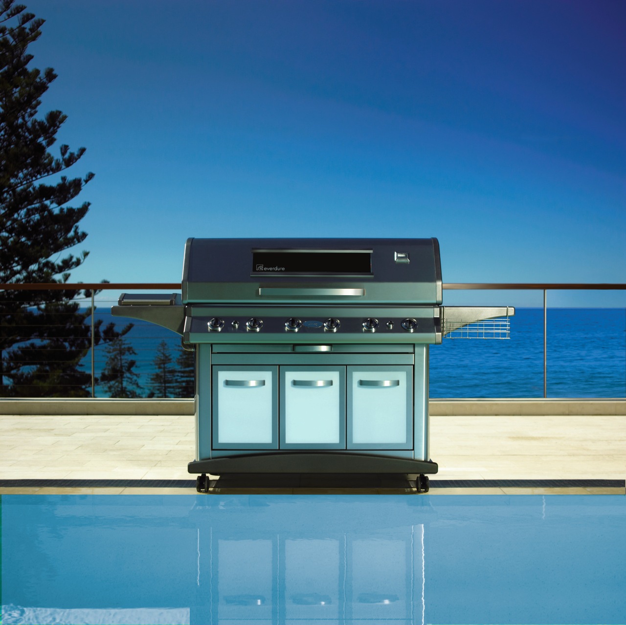 A view of a large steel BBQ in daylighting, teal, blue