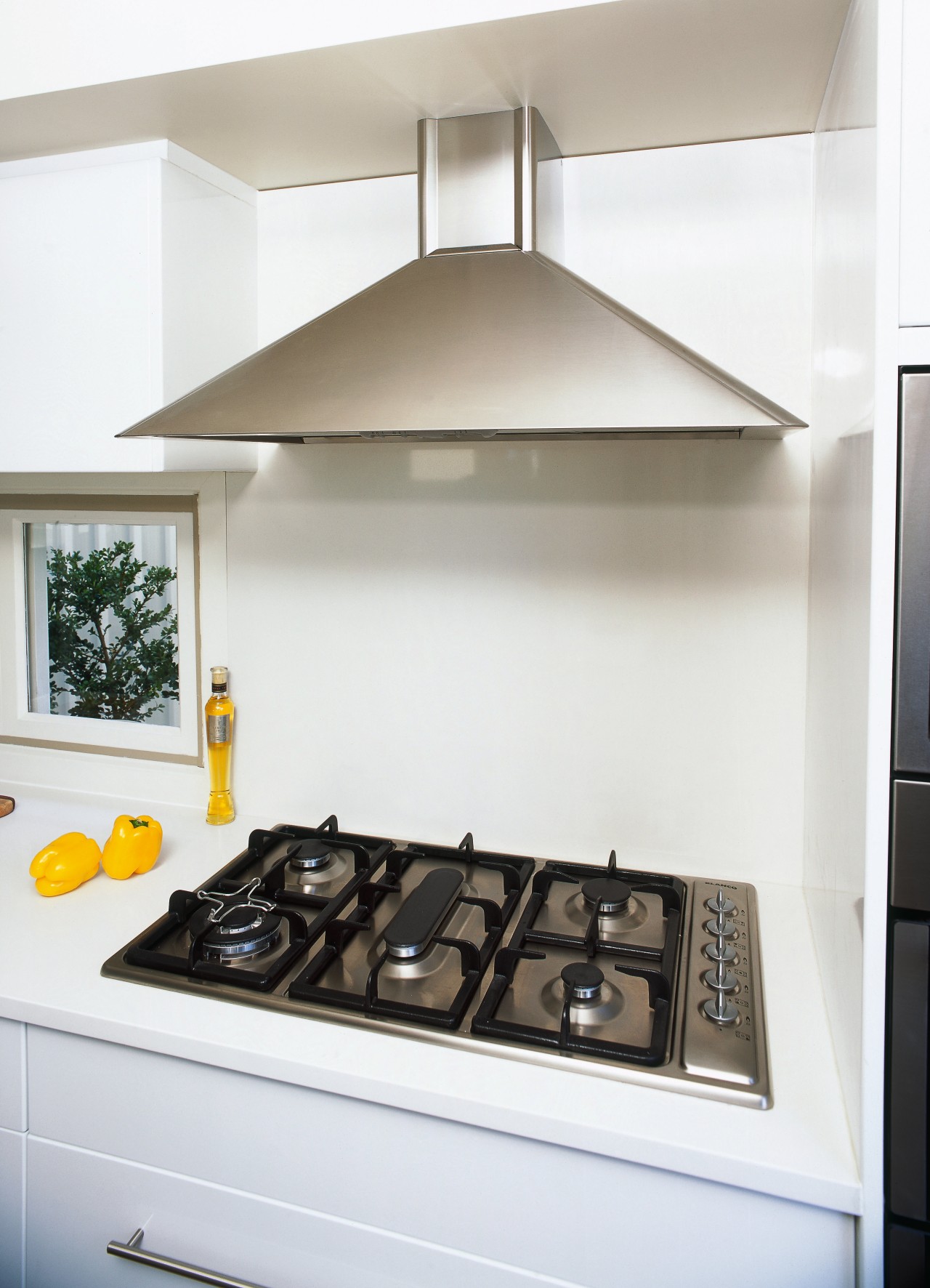 A close up view of the cooking area, countertop, home appliance, interior design, kitchen, kitchen stove, product design, white, gray