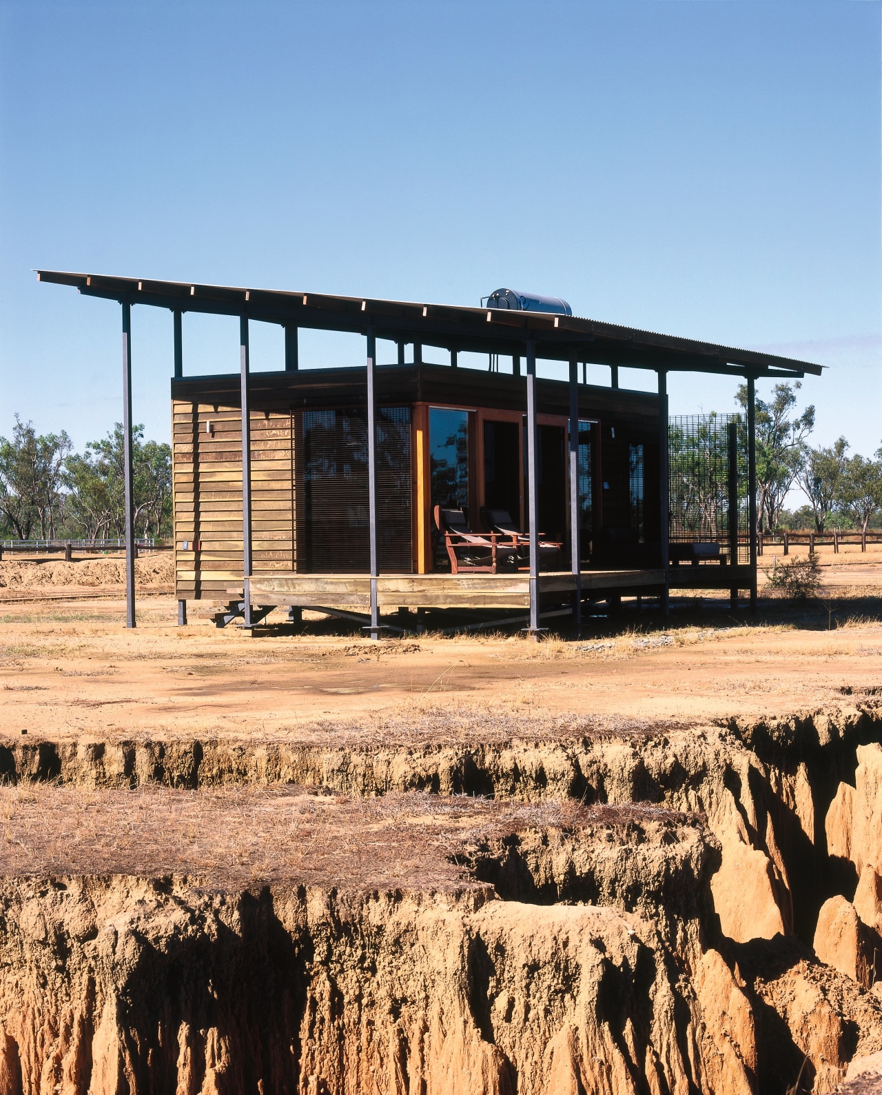 view of the timbe rguest cabins that area house, landscape, real estate, rural area, shed, teal, orange