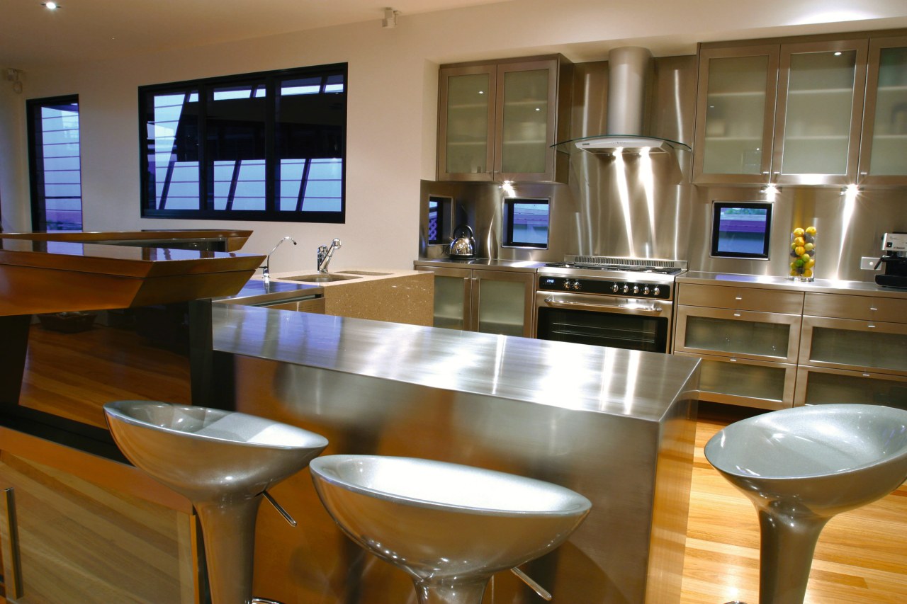 Kitchen with stainless steel appliances and splashback, bar countertop, interior design, kitchen, real estate, brown