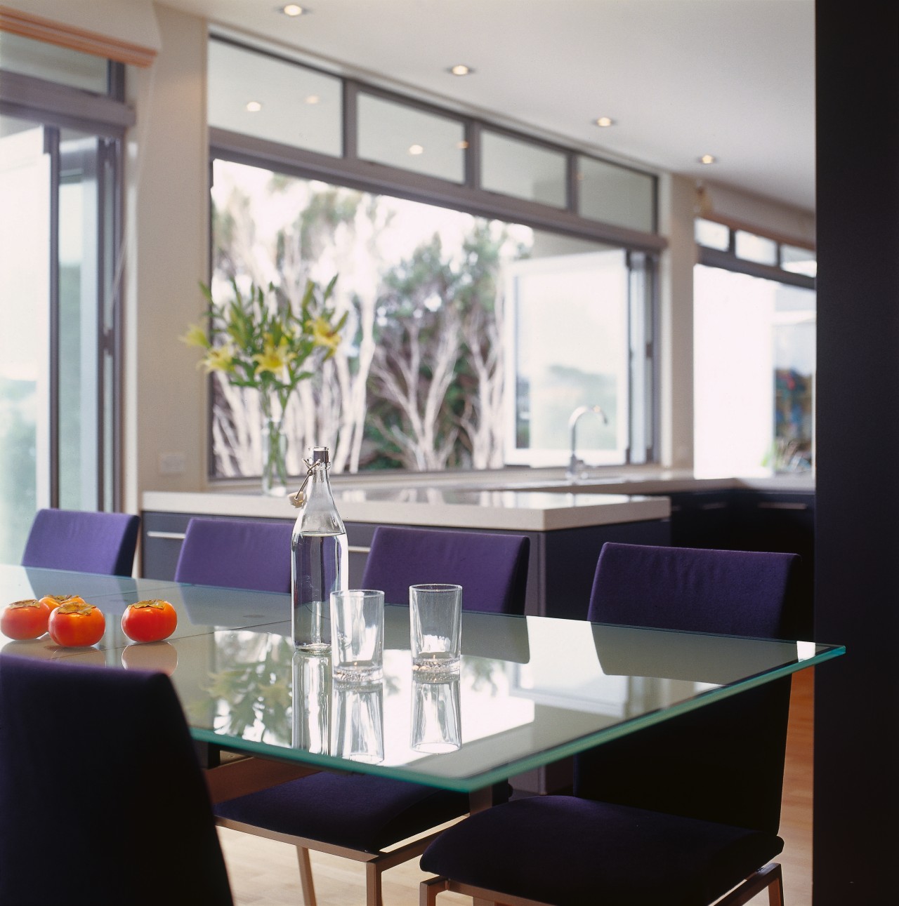 view of the kitchen and dining area with dining room, furniture, interior design, living room, restaurant, room, table, window, gray, white