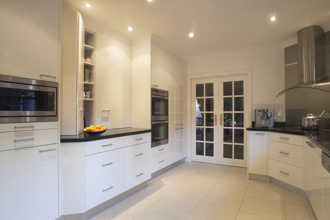 Kitchen with reflective black granite benchtops, light coloured cabinetry, countertop, cuisine classique, floor, flooring, home appliance, interior design, kitchen, property, real estate, room, orange