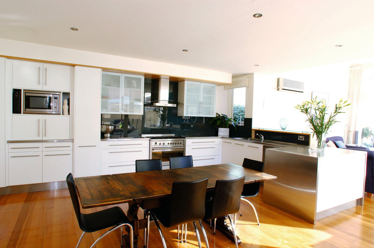 A view of a kitchen area, wooden flooring, ceiling, dining room, floor, flooring, house, interior design, kitchen, living room, property, real estate, room, table, white