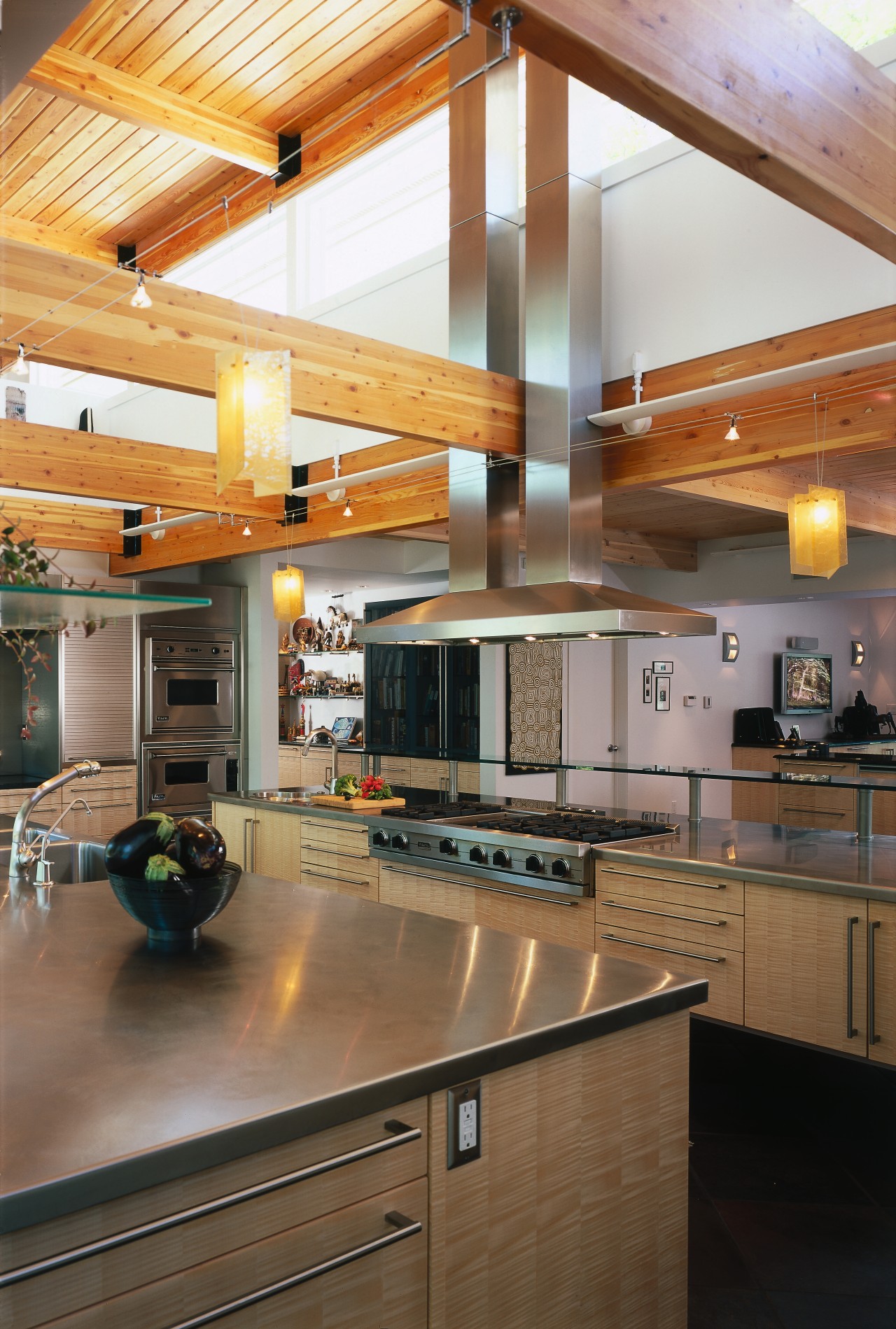 view of the kitchen featuring light wood veneer cabinetry, ceiling, countertop, daylighting, interior design, kitchen, real estate, room, wood, brown