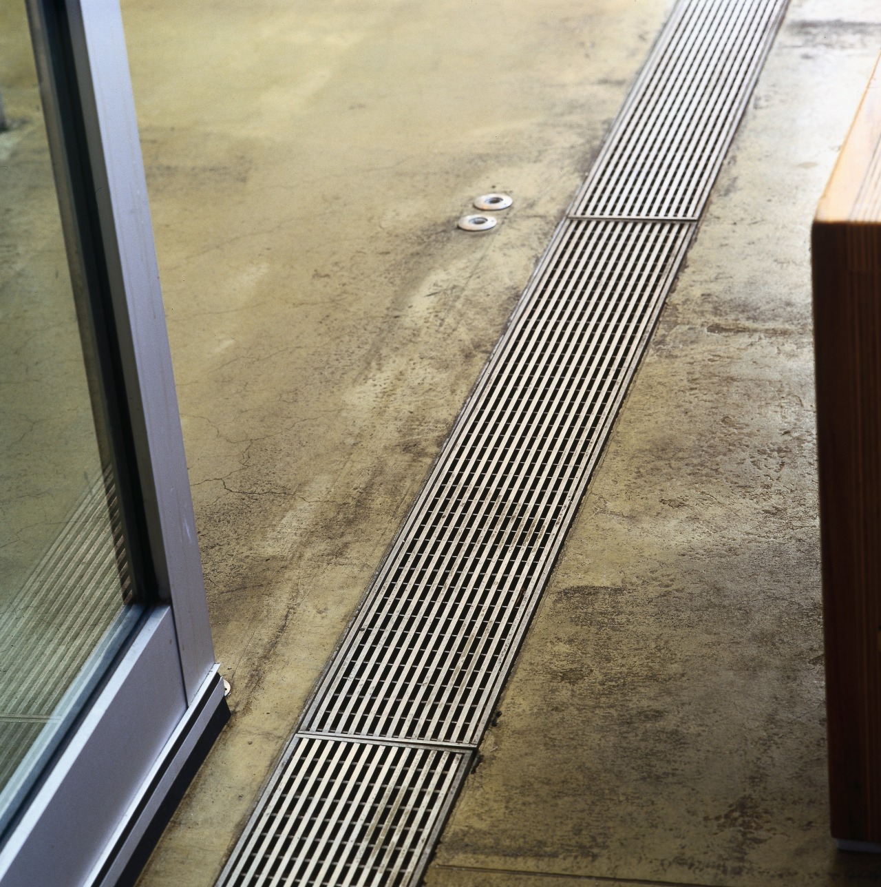 Stainless steel grating in floor of kitchen. floor, line, metal, steel, orange