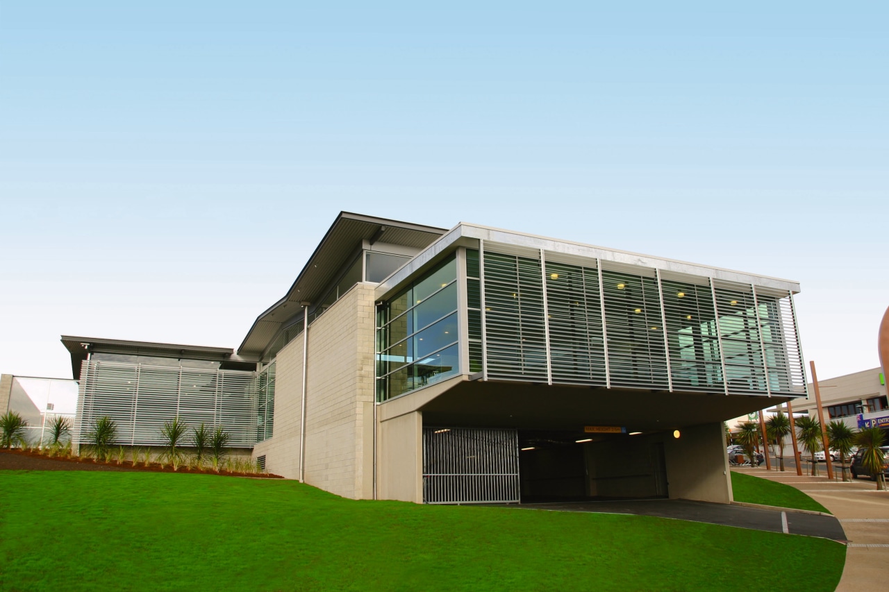 Exterior view of building featuring brick cladding, windows, architecture, building, corporate headquarters, elevation, facade, grass, home, house, mixed use, real estate, residential area, white