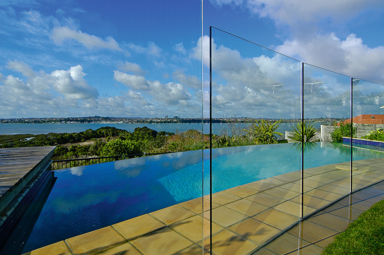 view of this  infinity edge pool that cloud, condominium, daytime, estate, horizon, leisure, property, real estate, reflection, sea, sky, swimming pool, water, teal, blue