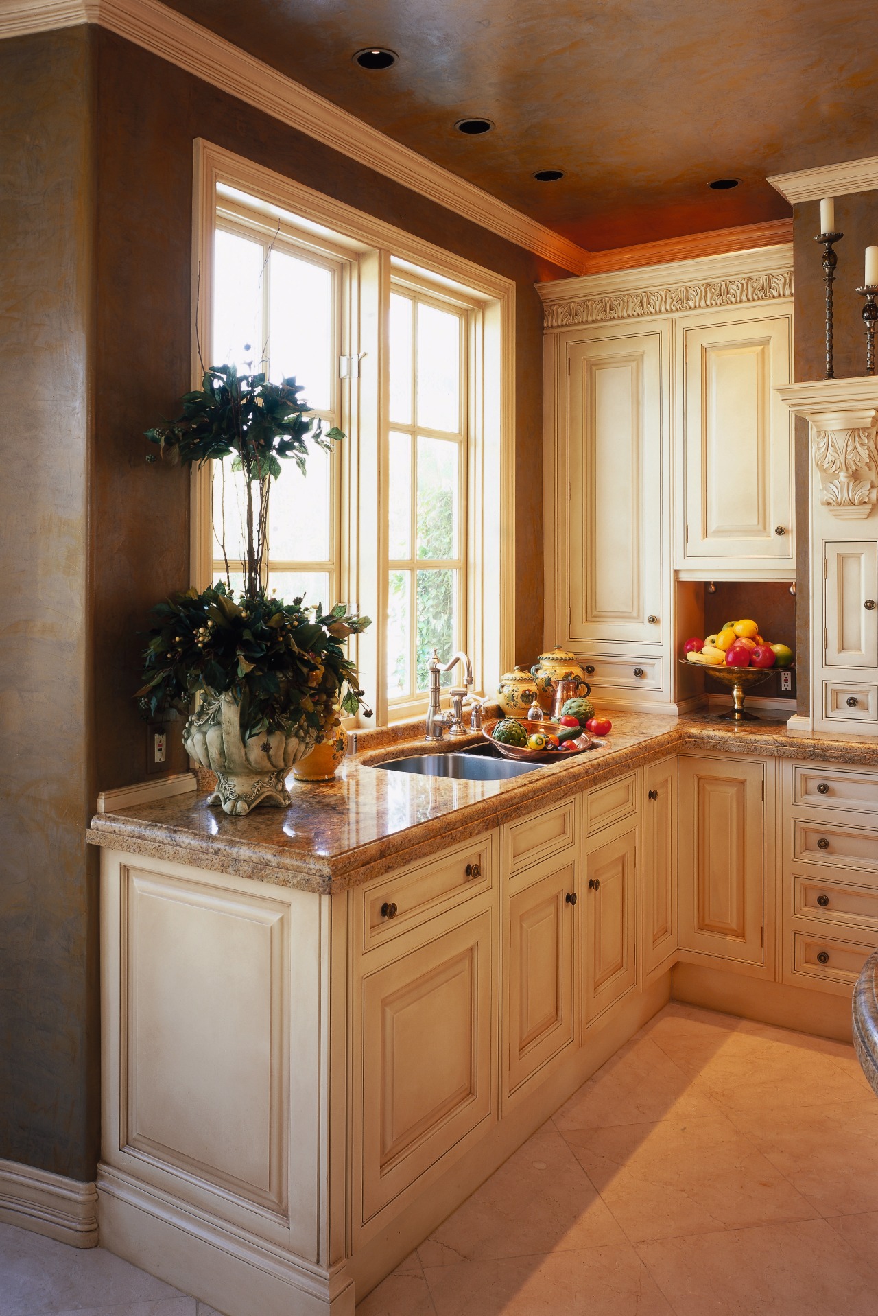 view of the antique cream kitchen cabinetry with cabinetry, countertop, cuisine classique, furniture, home, interior design, kitchen, room, brown