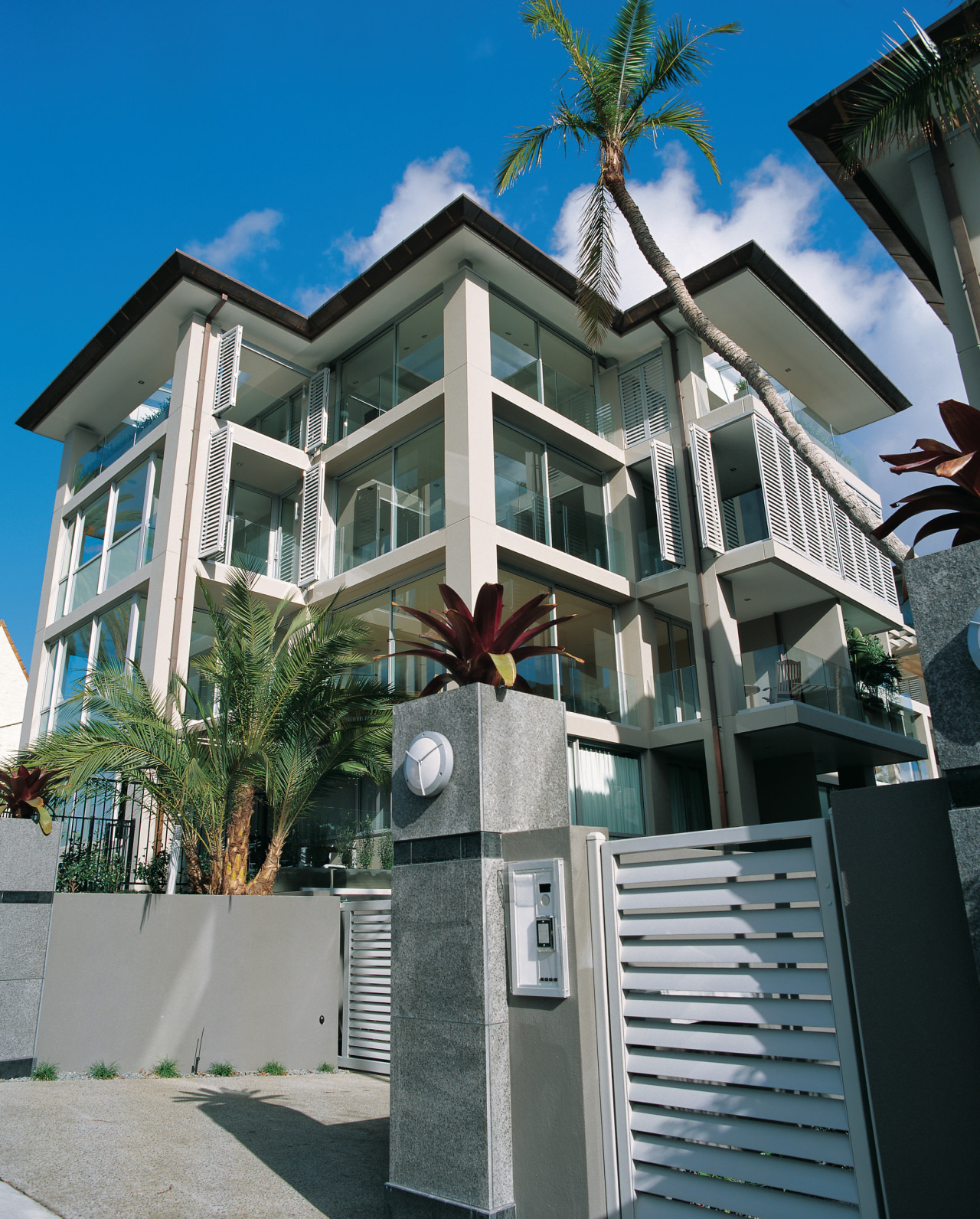 Exterior view of apartment building with large windows. apartment, architecture, building, condominium, estate, facade, home, house, mansion, mixed use, neighbourhood, property, real estate, residential area, window, gray, black