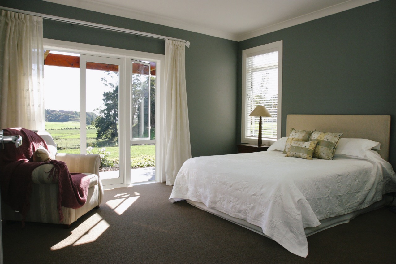 A view of a bedroom, dark green walls, bed, bed frame, bedroom, ceiling, curtain, floor, furniture, home, interior design, mattress, property, real estate, room, textile, window, window covering, window treatment, gray, black