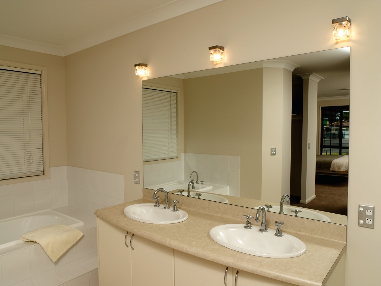 Bathroom with cream walls, twin vanity, large mirror bathroom, floor, home, interior design, property, real estate, room, sink, wall, window, orange, brown