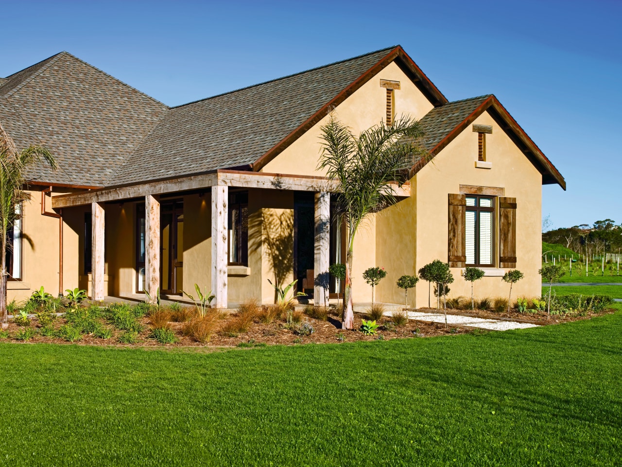 view of the country home featuring pabco advantage cottage, elevation, estate, facade, farmhouse, grass, home, house, landscape, landscaping, lawn, mansion, property, real estate, residential area, roof, siding, villa, window, brown