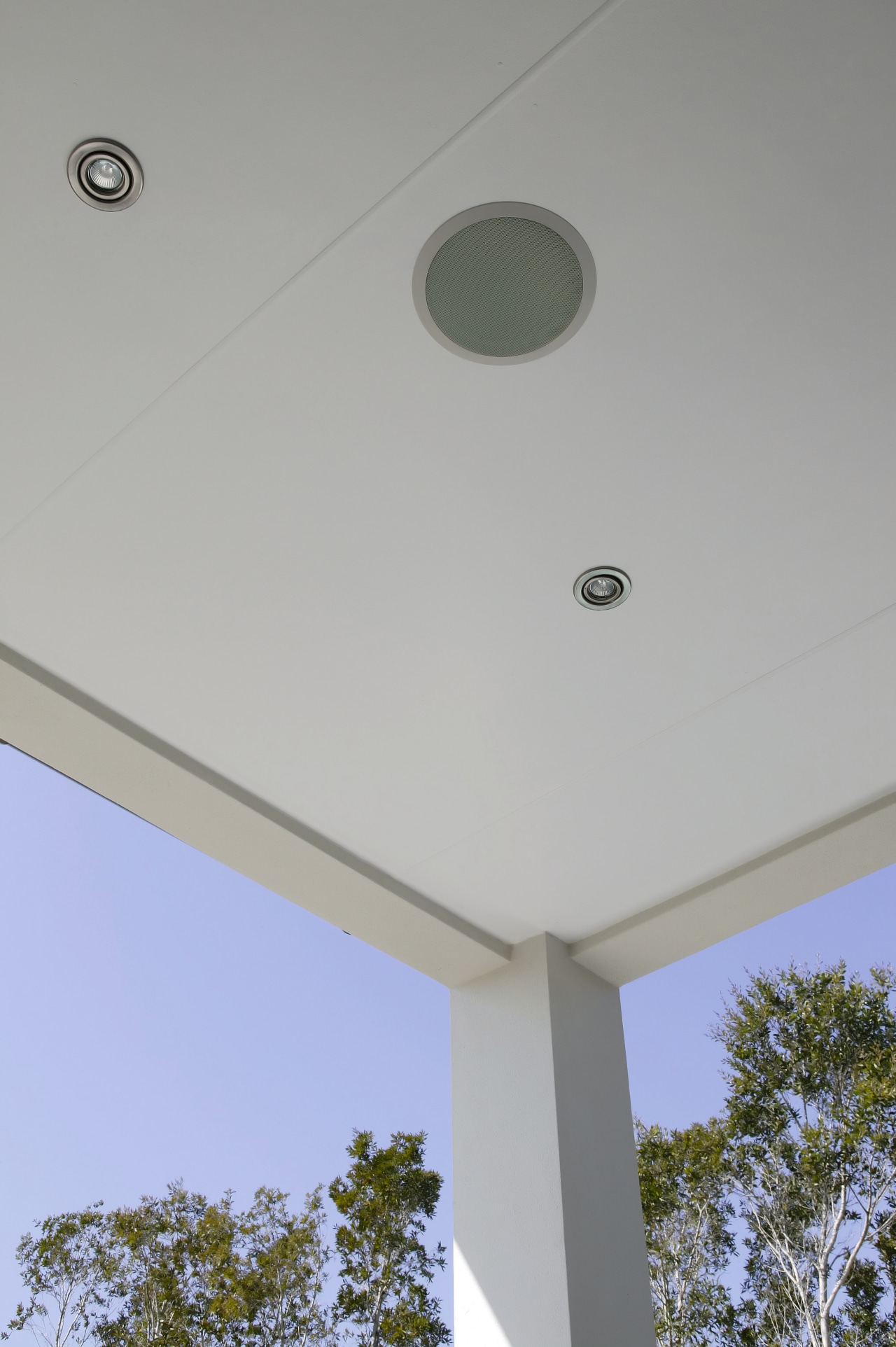 View of speakers installed into patio ceiling. architecture, ceiling, daylighting, daytime, house, light fixture, lighting, line, product design, sky, structure, gray