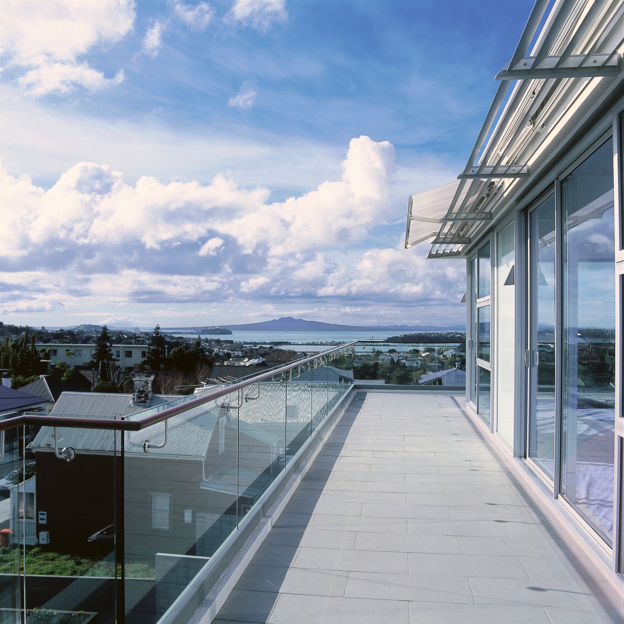 A view from the balcony, tiled ground, glass apartment, architecture, building, cloud, condominium, daylighting, estate, home, house, property, real estate, residential area, roof, sky, window, gray