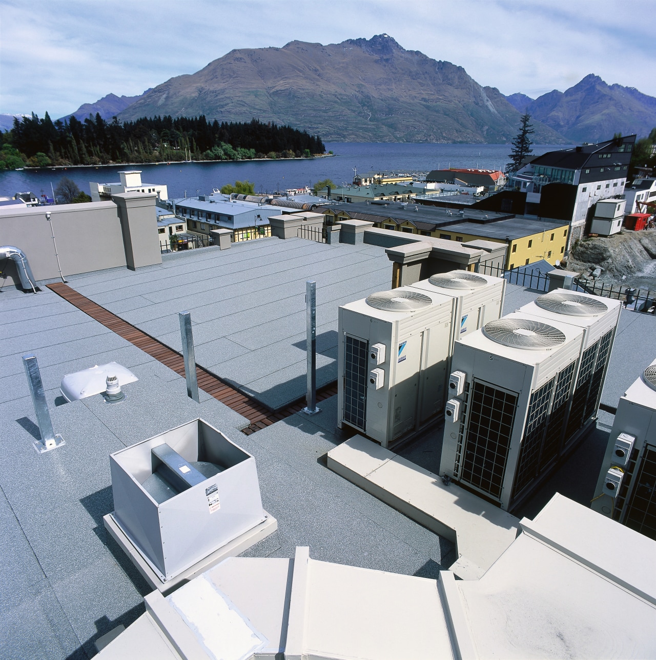 An exterior view of the heating and cooling architecture, roof, water, gray