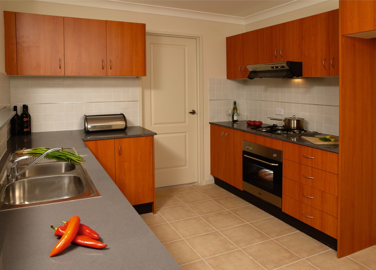 A view of a kitchen, wooden cabinetry, grey cabinetry, countertop, cuisine classique, floor, flooring, hardwood, home, interior design, kitchen, property, real estate, room, brown