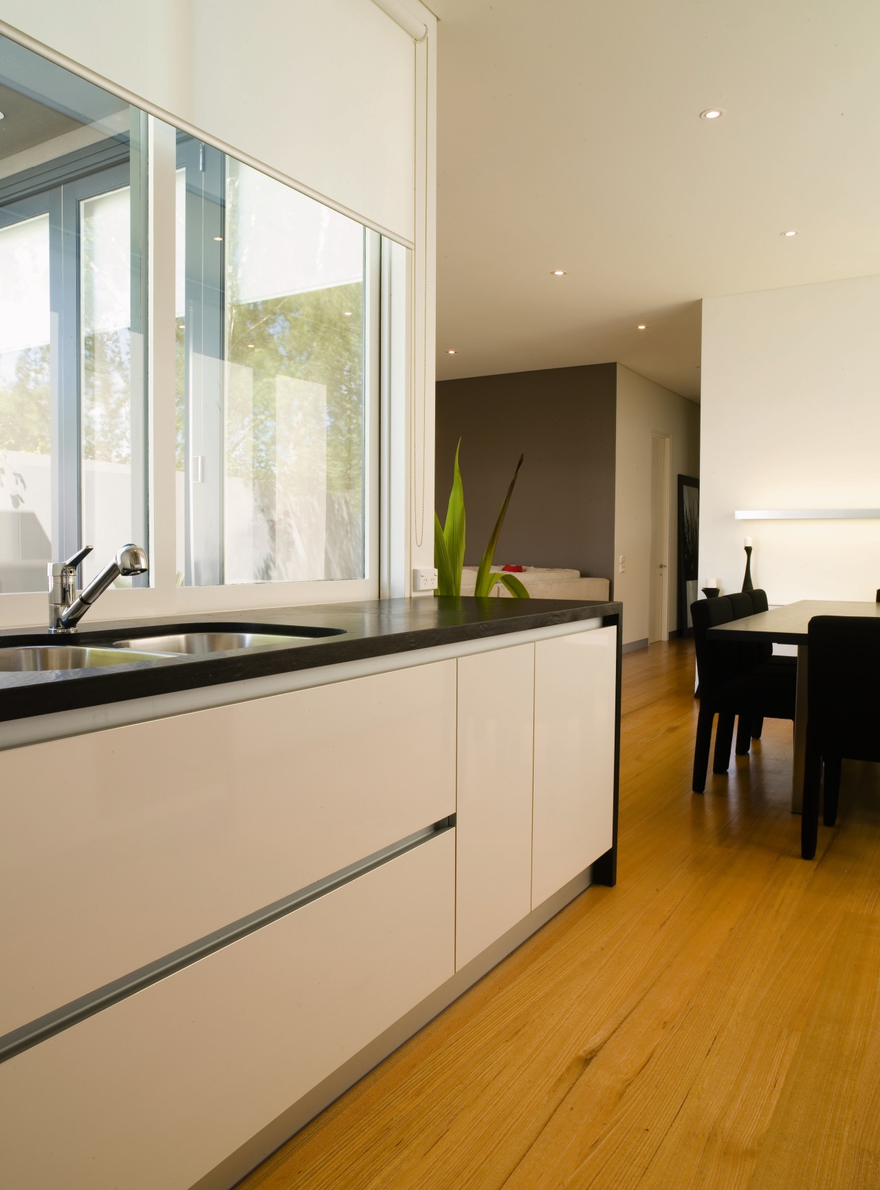 A view of a kitchen, wooden flooring and architecture, countertop, floor, flooring, hardwood, house, interior design, kitchen, real estate, room, window, wood flooring, white