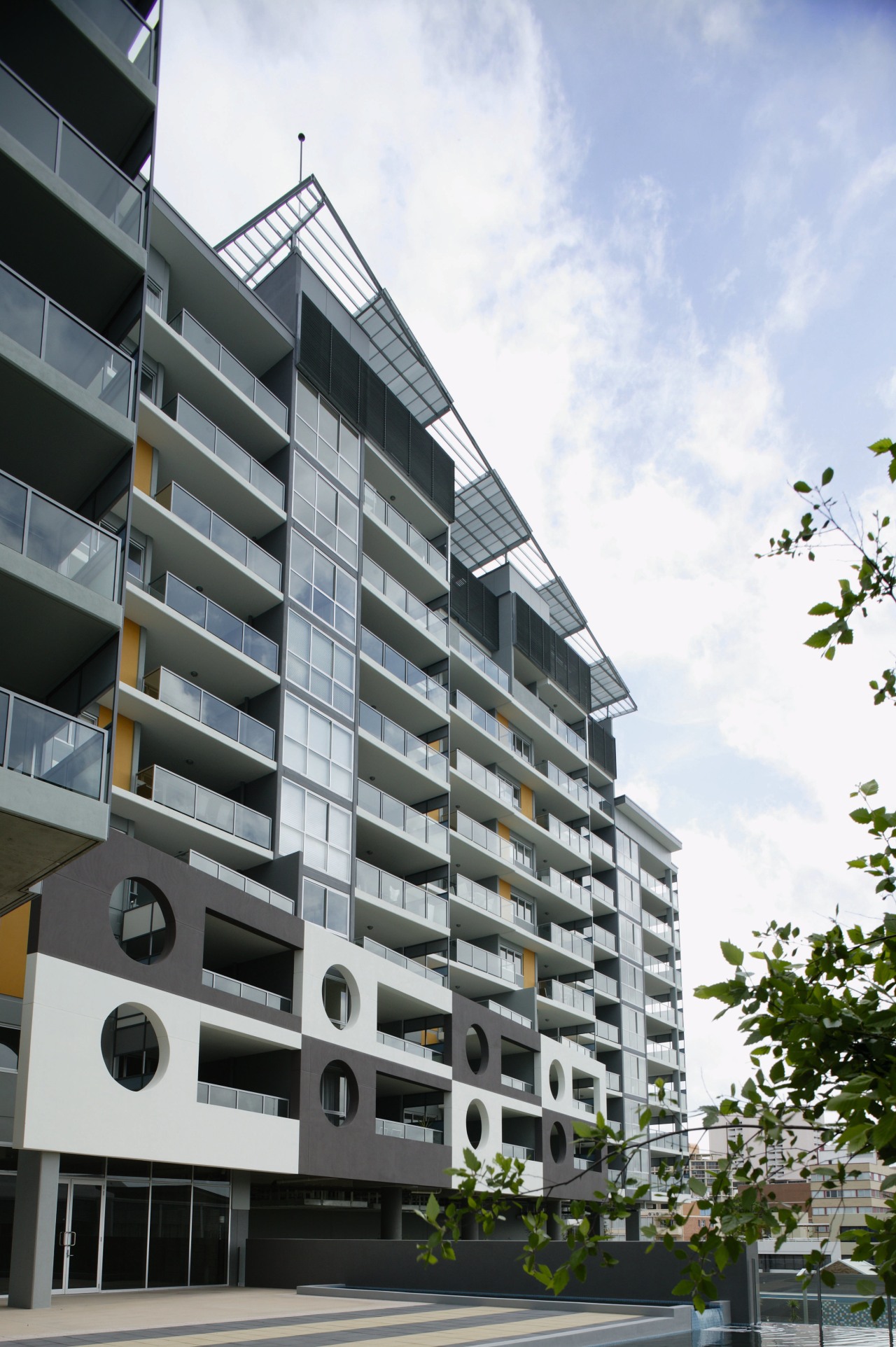 An exterior view of some apartments. apartment, architecture, building, commercial building, condominium, corporate headquarters, daytime, elevation, facade, home, house, metropolitan area, mixed use, neighbourhood, property, real estate, residential area, sky, tower block, urban design, white, gray