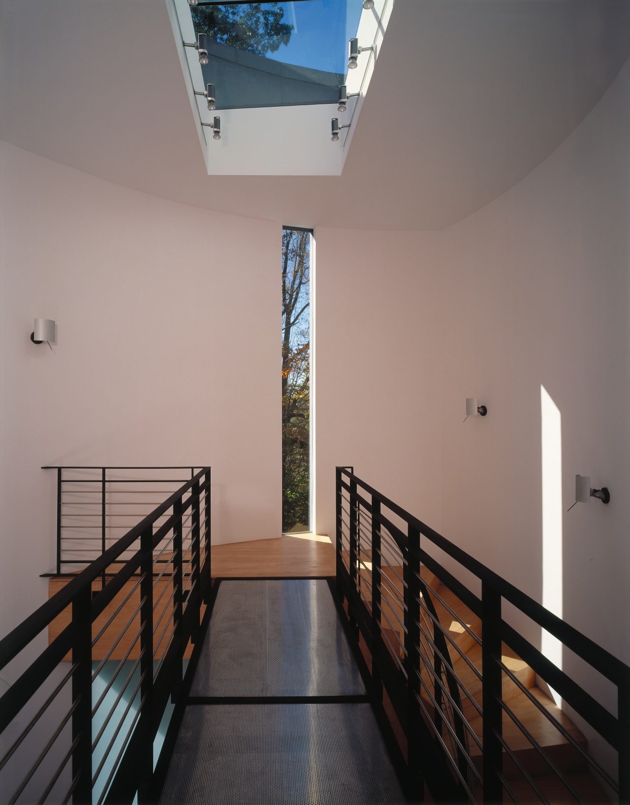 A view of a hallway, wooden flooring, white apartment, architecture, ceiling, daylighting, estate, floor, handrail, home, house, interior design, property, real estate, stairs, window, wood, gray