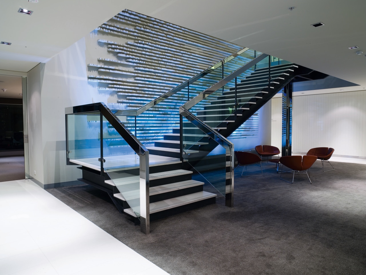 A view of a glass staircase. architecture, ceiling, condominium, daylighting, glass, handrail, interior design, real estate, stairs, gray, black