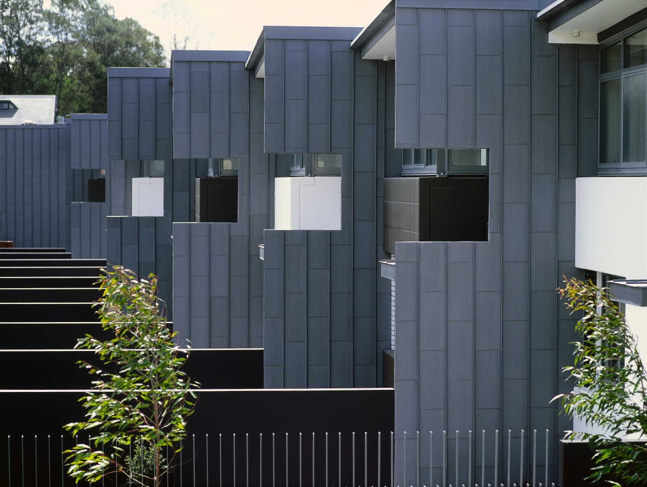 A exterior view of the material used on architecture, building, facade, fence, gate, home, house, real estate, residential area, shed, siding, black, gray