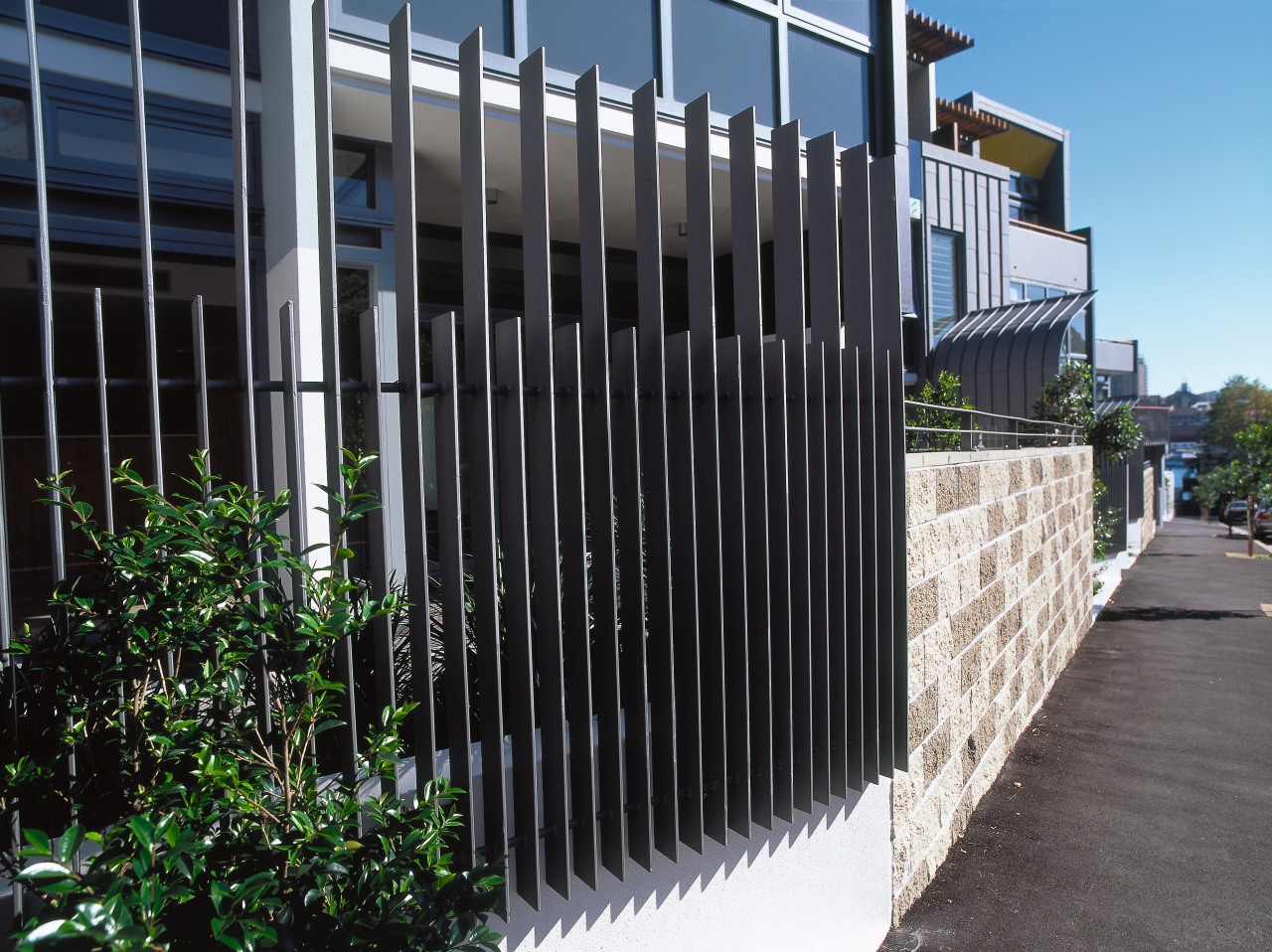 A view of an iron fence. architecture, building, facade, fence, home fencing, house, iron, outdoor structure, property, real estate, residential area, black