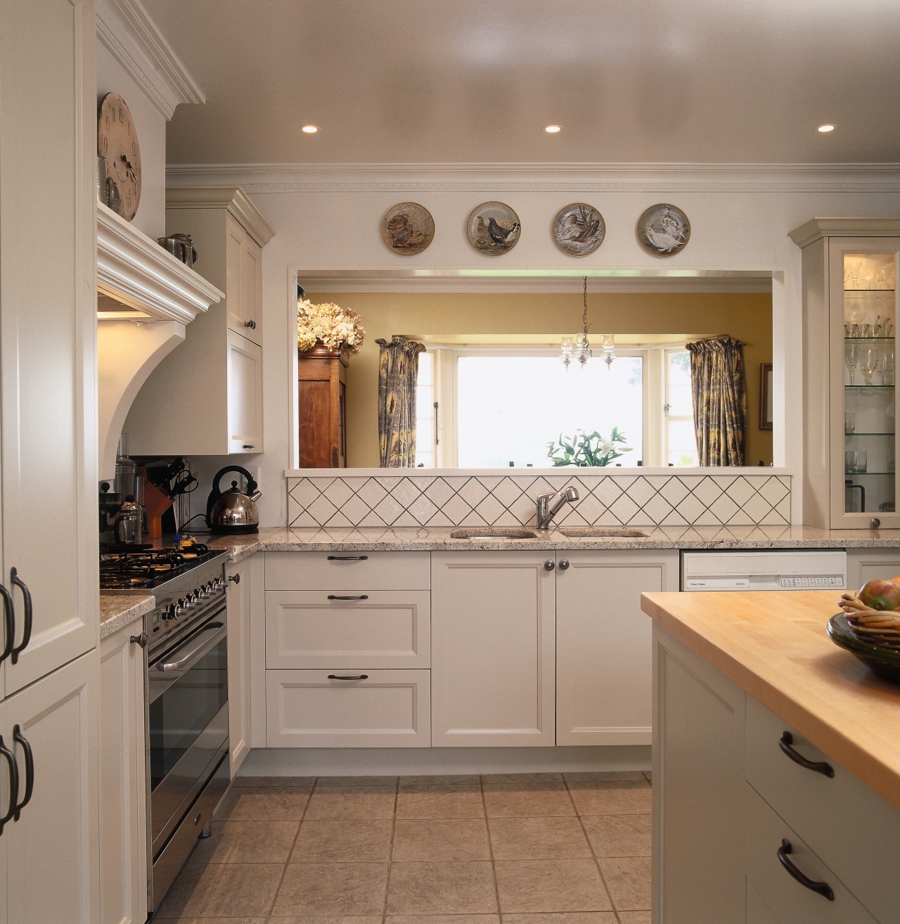 An example of one of Debra DeLorenzo's style cabinetry, ceiling, countertop, cuisine classique, floor, flooring, home, home appliance, interior design, kitchen, property, real estate, room, under cabinet lighting, window, wood flooring, gray, brown