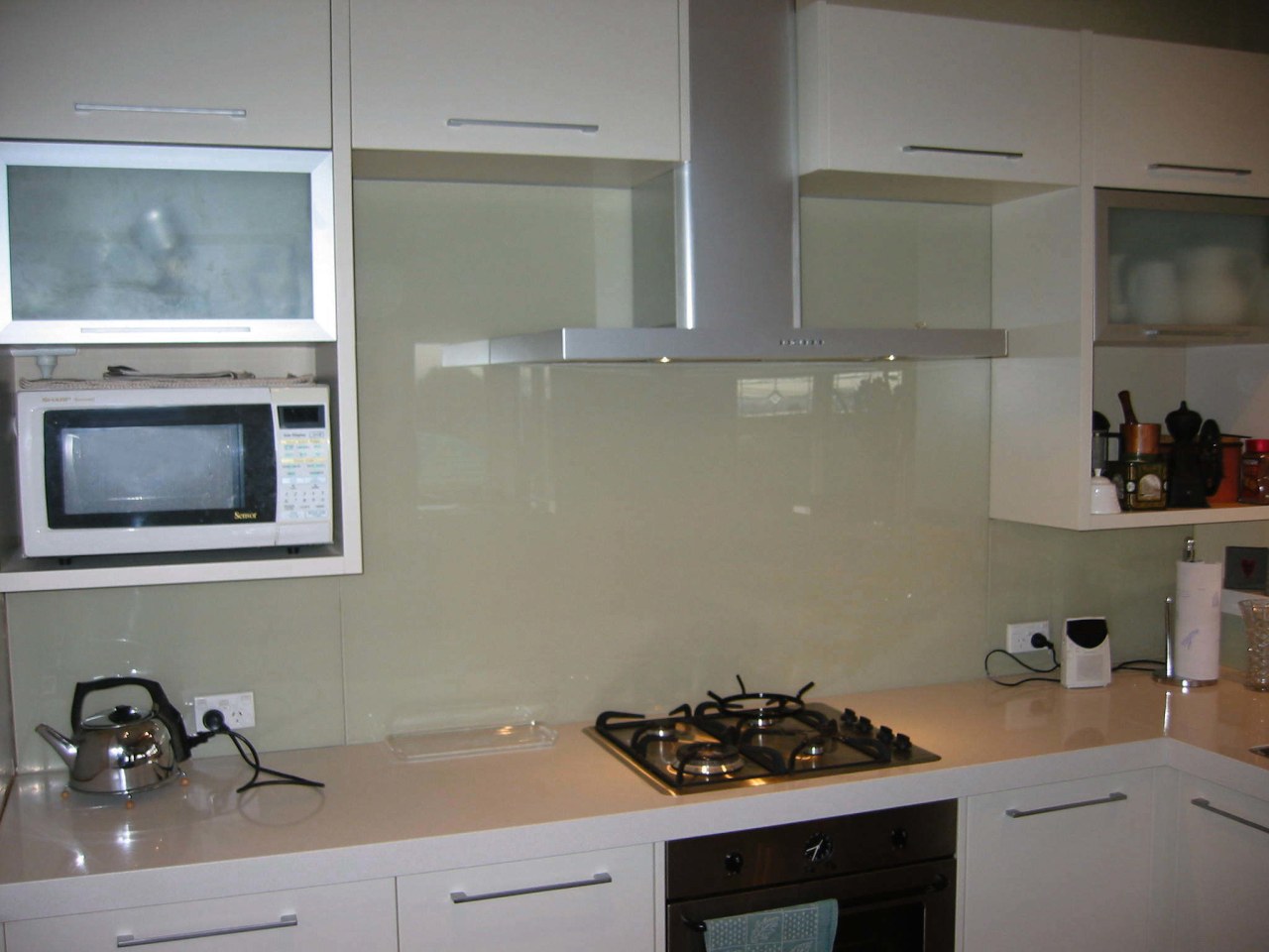 Examples of how glass splashbacks from Glass Solutions cabinetry, countertop, flooring, glass, interior design, kitchen, room, under cabinet lighting, gray