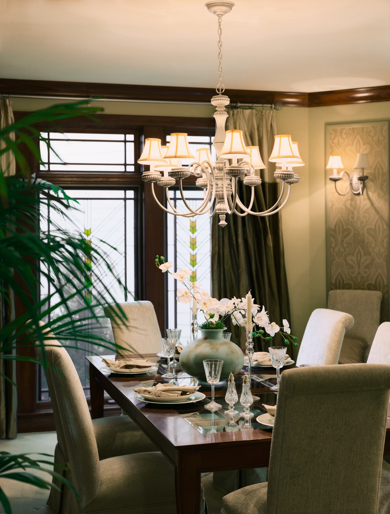 Dining room in a model home with upholstered chandelier, dining room, furniture, home, interior design, light fixture, lighting, living room, restaurant, room, table, window, brown, orange