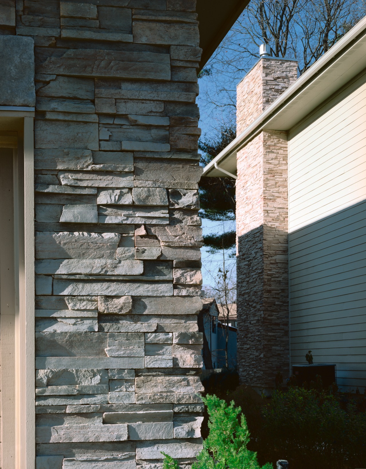 Closeup view of exterior stone siding. architecture, brick, brickwork, facade, home, house, siding, stone wall, structure, wall, window, wood, black