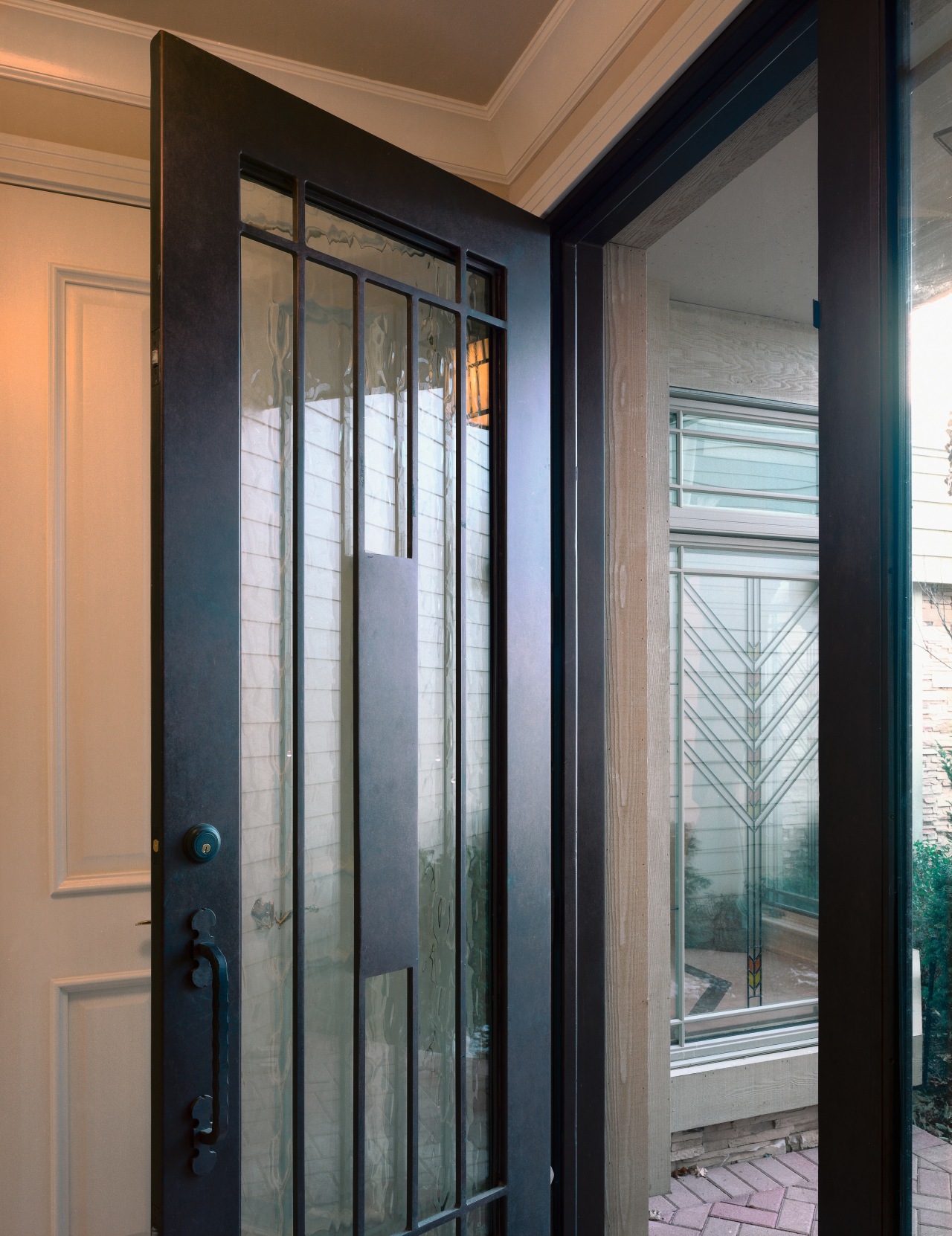 Closeup of wrought iron and glass entry door. door, glass, home, interior design, window, gray, black