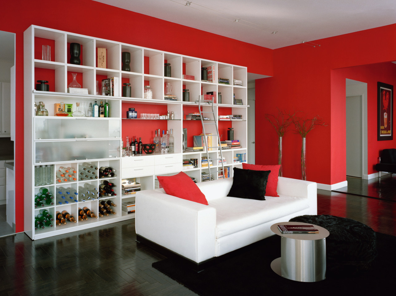 designed by ddc, this apartment on the 78th bookcase, furniture, interior design, living room, room, shelf, shelving, gray, red