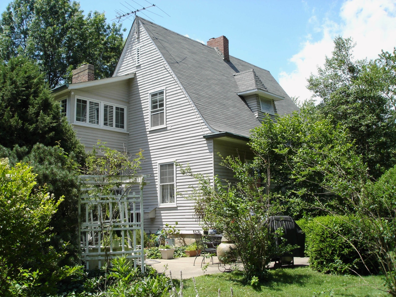 Maintaining the historic aspect of this home was backyard, cottage, estate, facade, farmhouse, garden, historic house, home, house, landscaping, neighbourhood, outdoor structure, plant, property, real estate, residential area, roof, siding, suburb, tree, window, yard