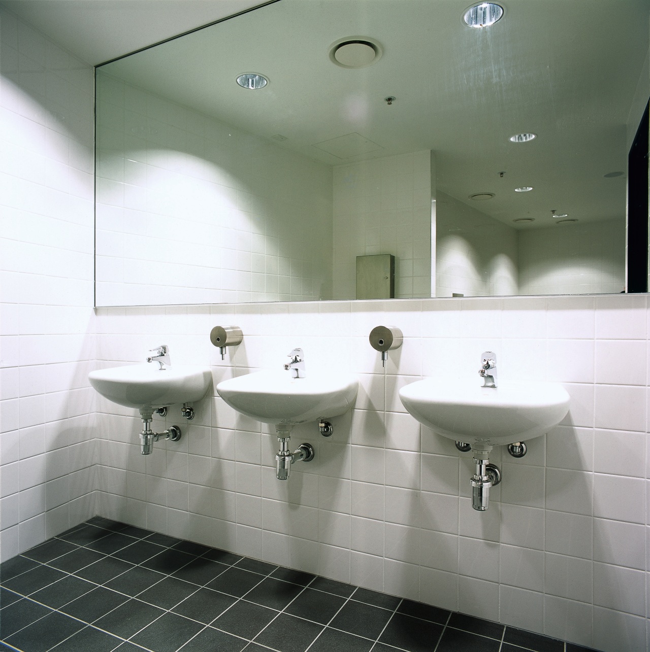 Public bathroom with wall mounted basins, large mirror architecture, bathroom, bathroom sink, bidet, ceiling, daylighting, floor, interior design, plumbing fixture, product design, property, public toilet, room, sink, tap, tile, toilet seat, wall, gray