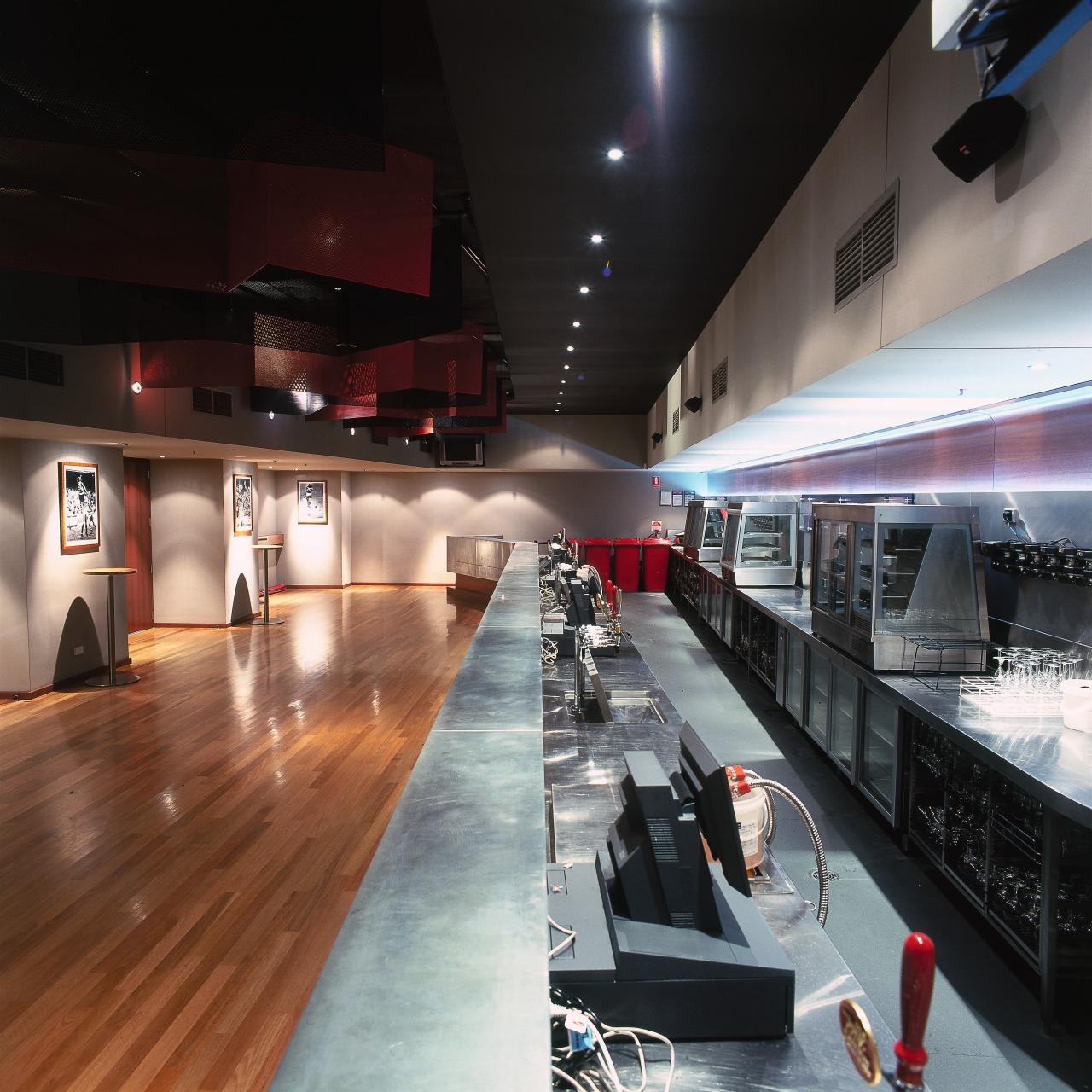 View of bar area with varied lighting, timber interior design, black, gray