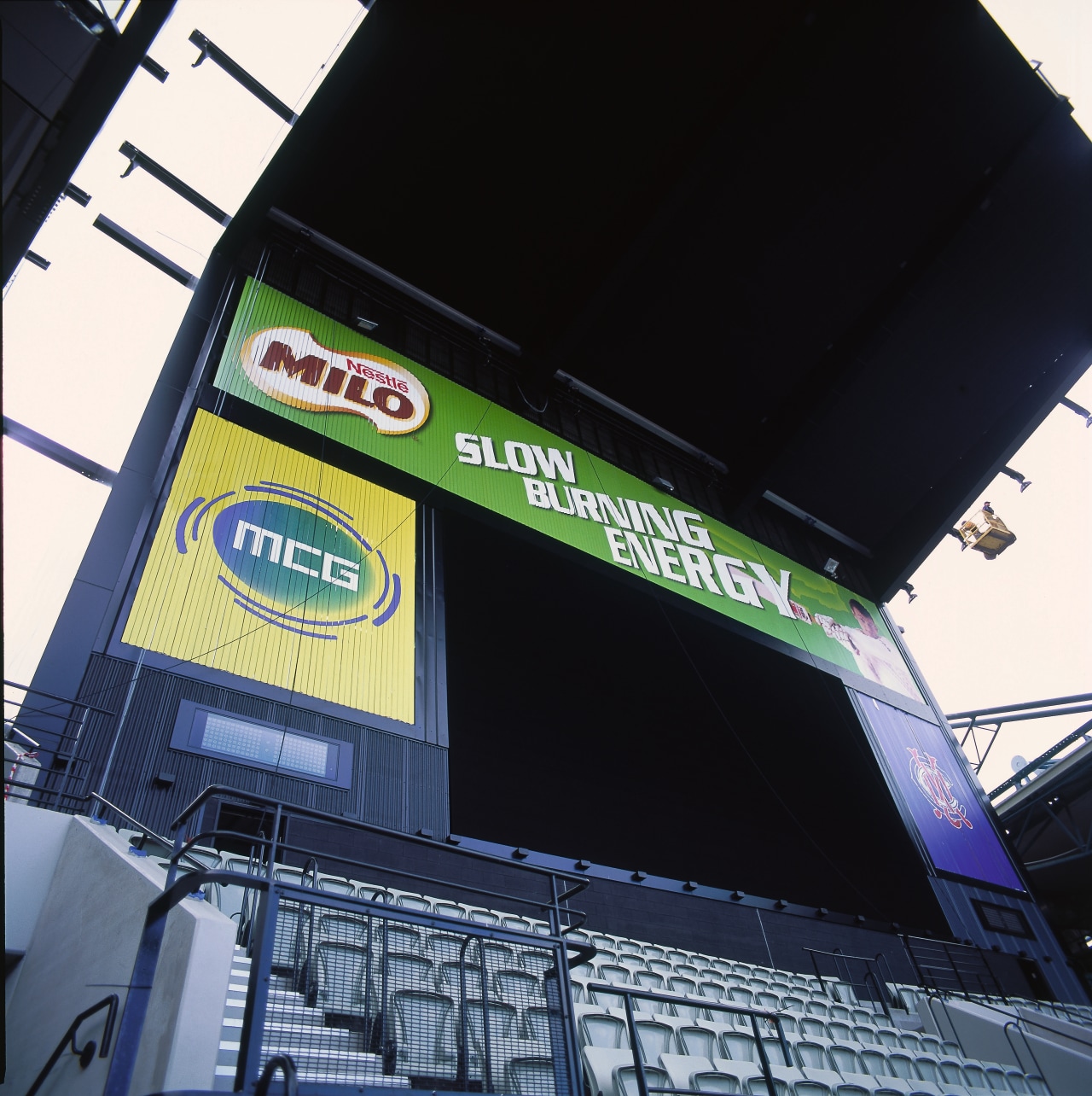 View of large screen and advertising at sports advertising, building, car, sport venue, structure, technology, black