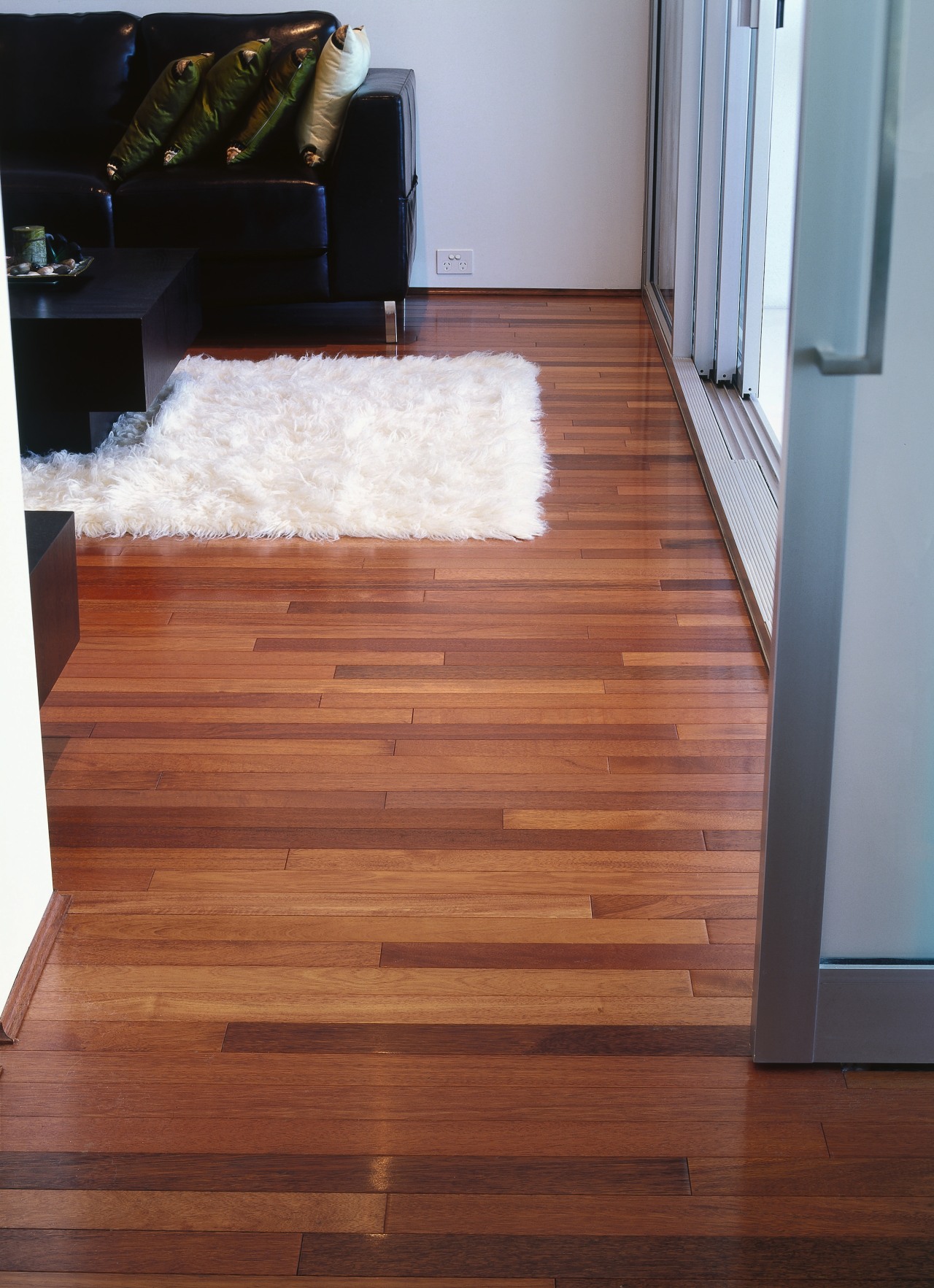 Lounge room with timber flooring, white rug and floor, flooring, hardwood, interior design, laminate flooring, stairs, wood, wood flooring, wood stain, red