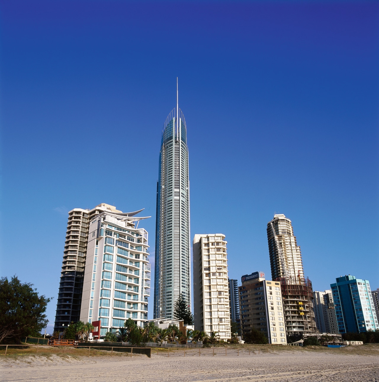 View of tall apartment buildings. building, city, cityscape, condominium, corporate headquarters, daytime, downtown, landmark, metropolis, metropolitan area, mixed use, sky, skyline, skyscraper, tower, tower block, urban area, blue