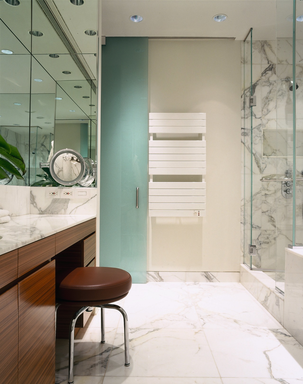 view of this bathroom featuring marble vein walls,floor bathroom, bathroom accessory, door, floor, flooring, glass, home, interior design, room, tile, white, gray