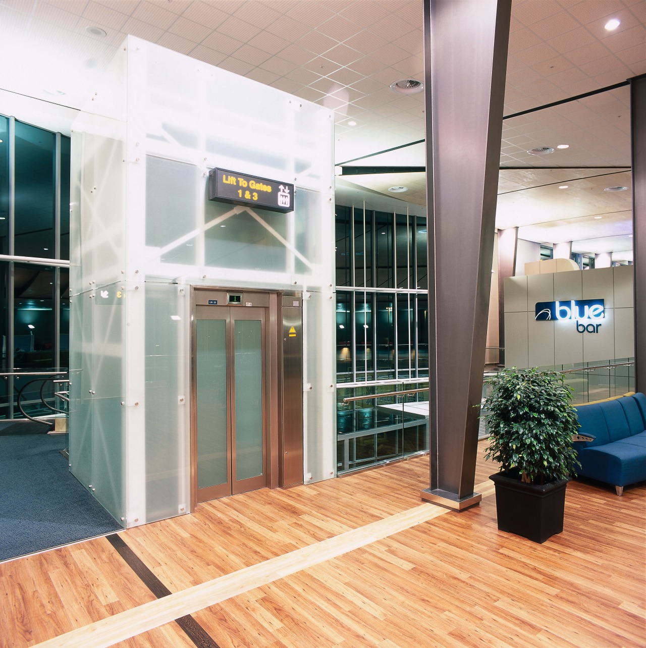 View of elevator with contemporary glass facade. ceiling, floor, flooring, glass, interior design, lobby, gray