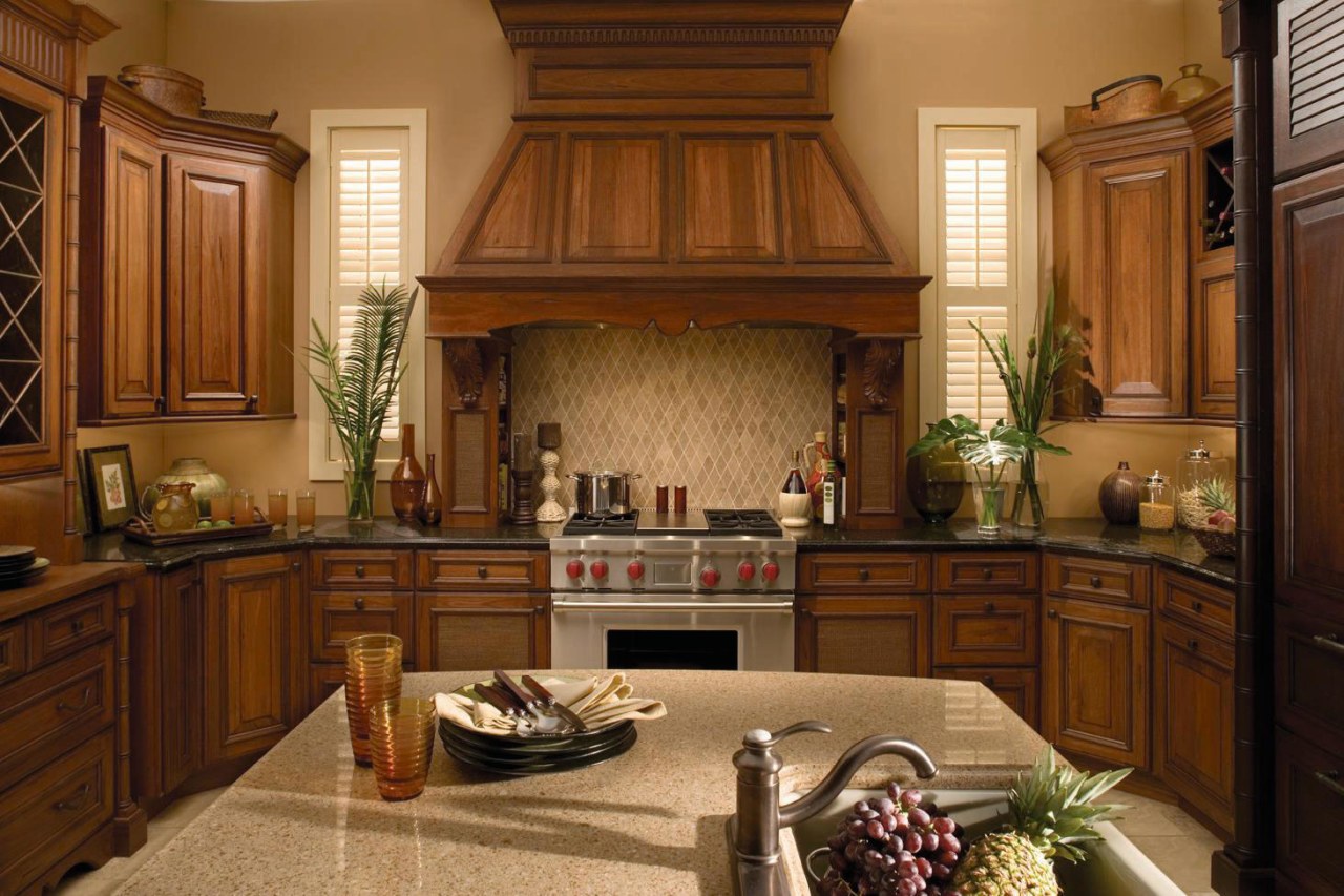 Traditional style kitchen with marble island with sink, cabinetry, countertop, cuisine classique, estate, furniture, hardwood, home, interior design, kitchen, room, under cabinet lighting, wood, brown