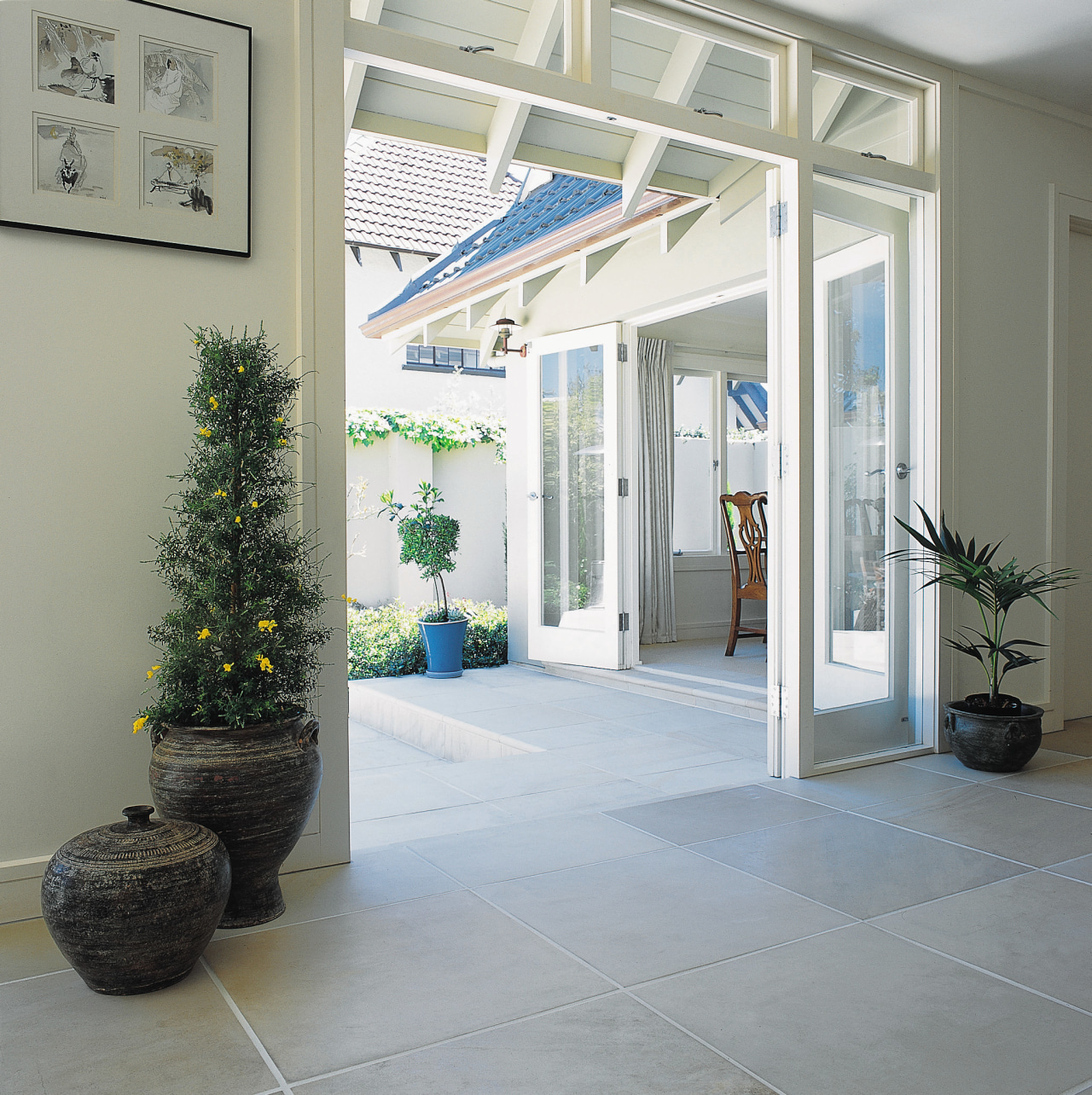 Room with sandstone paving flooring, extending outside to door, floor, glass, interior design, real estate, window, gray