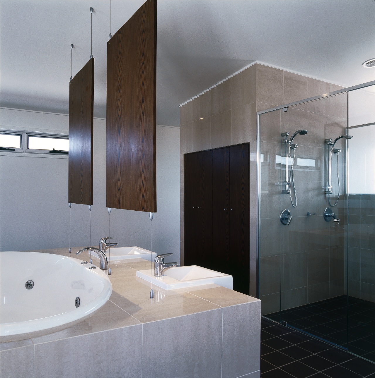 view of the bathroom featuring tiled flooring, glased architecture, bathroom, bathroom accessory, bathroom cabinet, interior design, plumbing fixture, room, sink, gray