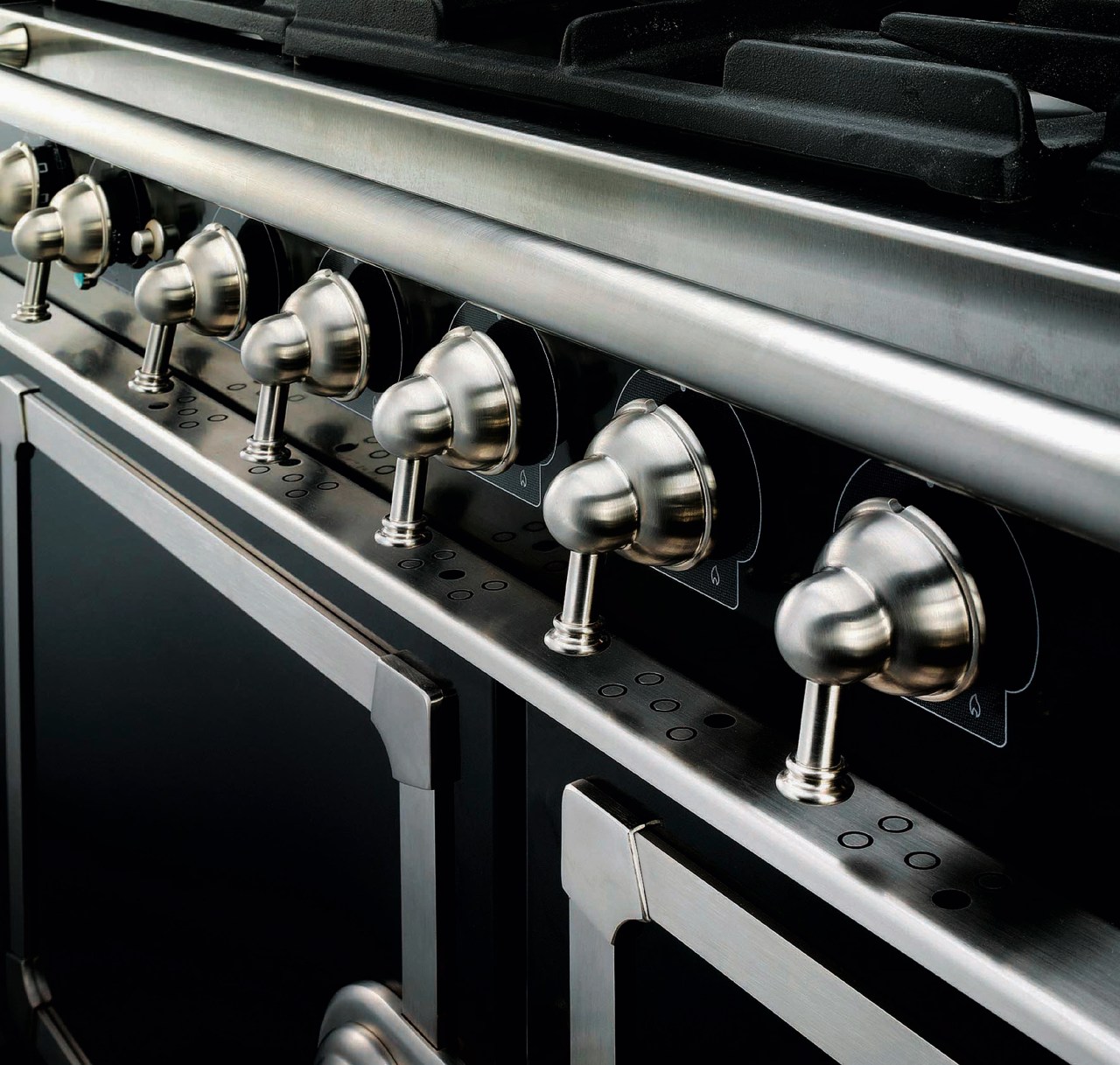 Closeup view of cooker control handles. automotive design, car, metal, motor vehicle, black, gray