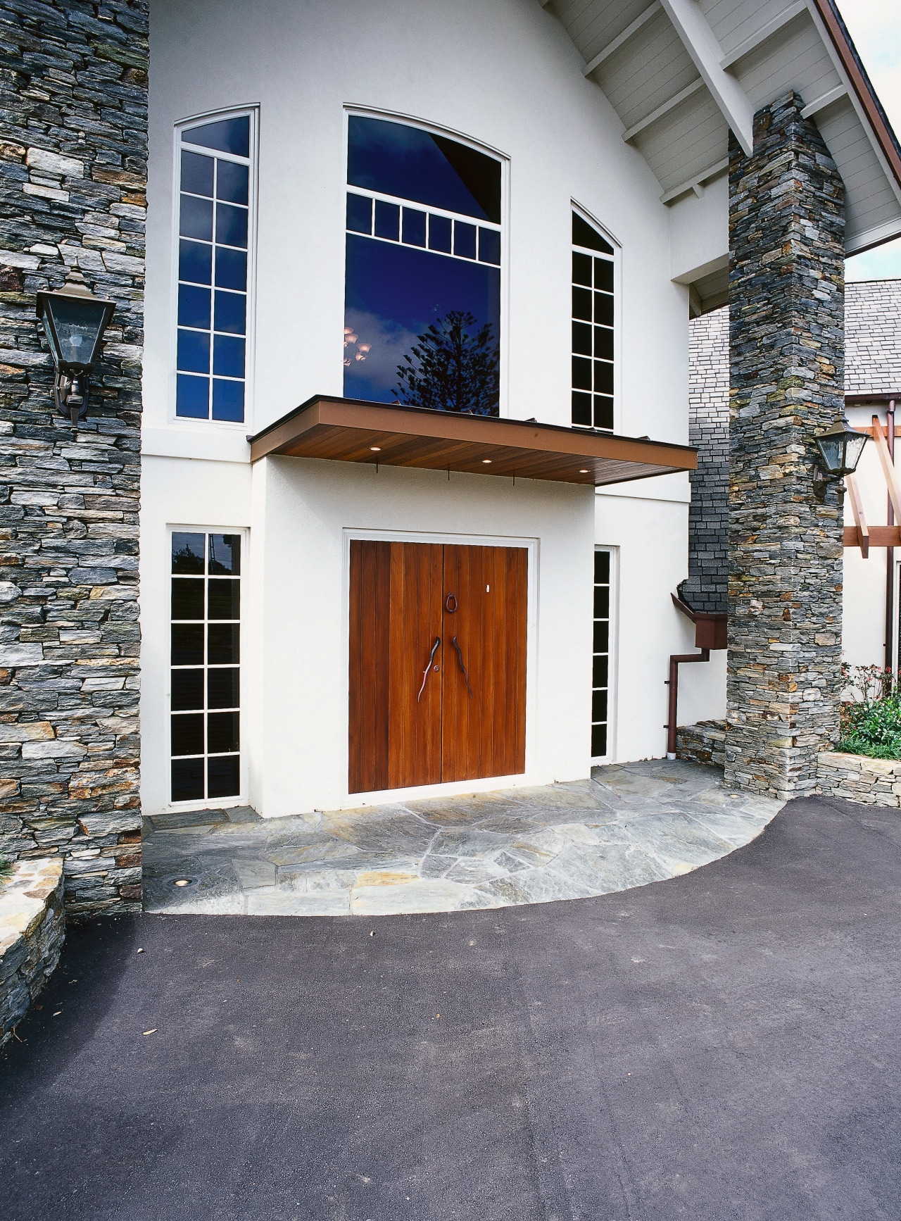 View of front entranceway of home with plaster building, door, facade, home, house, real estate, window, gray