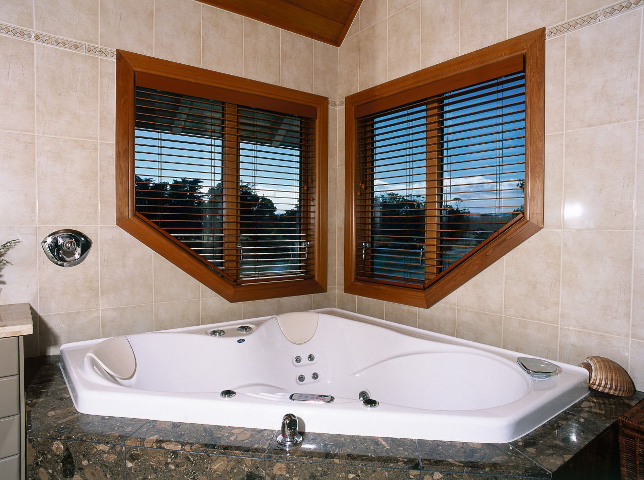 Bathroom with spa bath in corner and shaped bathroom, bathtub, estate, interior design, jacuzzi, property, real estate, room, window, gray