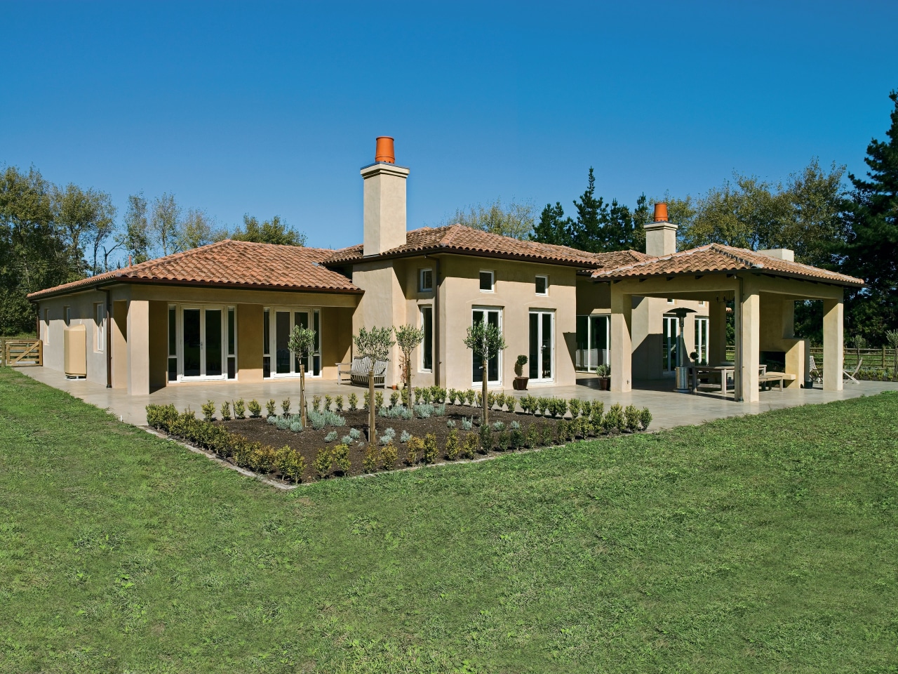 Exterior view of masonry home with patios and cottage, elevation, estate, facade, farmhouse, home, house, land lot, landscape, mansion, property, real estate, residential area, roof, villa, green, teal